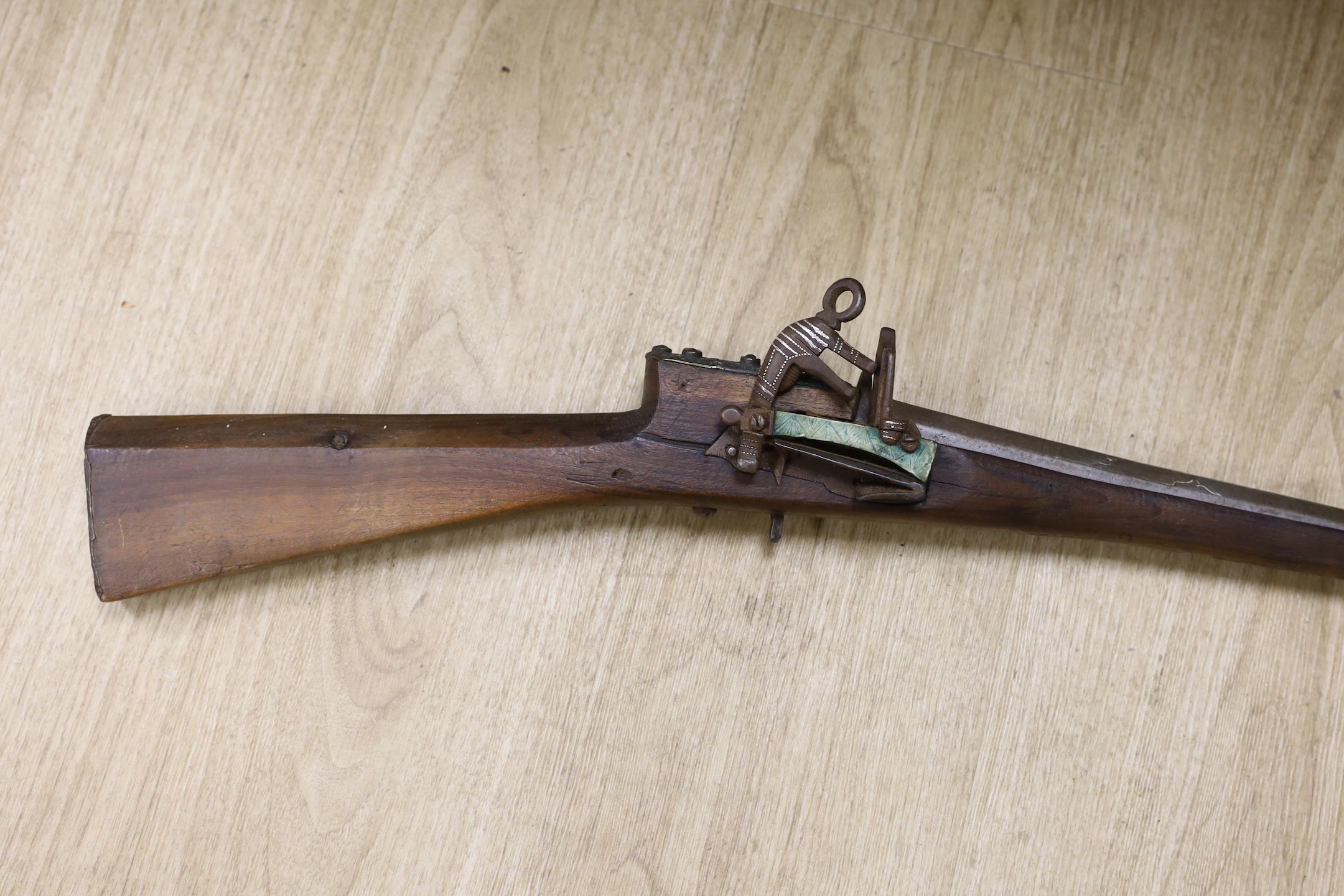 An Eastern decoratively metal mounted antique musket, 132cms long.